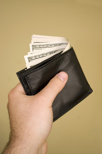 a-hand-holding-a-wallet-full-of-cash-isolated-over-a-gold-background_HtVes_PCBi_thumb.jpg