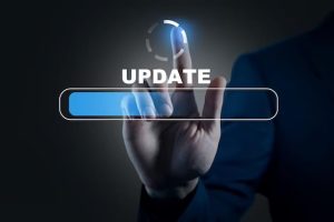 A man's hand is pressing the update button on a screen.